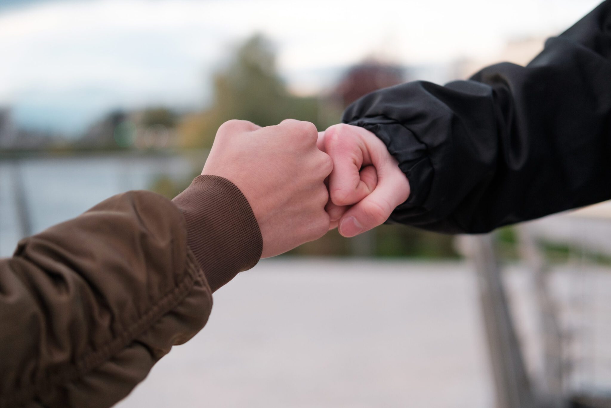 fist bump close-up. young people say hello fist outdoors fist. respect